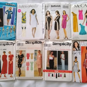 May include: Collection of vintage sewing patterns for dresses. The patterns are from brands like McCall's, Simplicity, and Butterick. The covers feature illustrations of the finished garments, with various styles and designs.