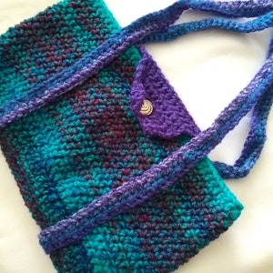 Bolso de crochet para tableta, acrílico verde azulado/morado, botón metálico, tiene correas para los hombros. Suave