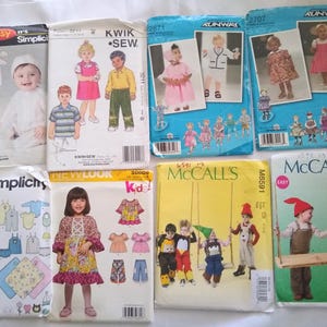 May include: A collection of children's sewing patterns featuring various designs for clothing. The patterns showcase outfits for babies and young children, with illustrations of the finished garments. Brands include Simplicity, Kwik Sew, McCall's, and New Look.