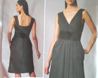 May include: A DKNY Vogue pattern for a sleeveless dress. The pattern shows the dress design from the front and back, with a V-neck and pleated skirt. The pattern is labelled V1235 and includes sizing details. The dress design is by Donna Karan New York.