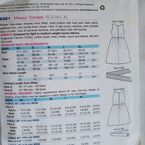 May include: Sewing pattern for misses' sleeveless dresses with fitted, lined bodice, bust and waist darts, gathered skirt, and centre back zip. View A has scoop neckline and contrast bias cut sash. View B has boat neckline and self fabric belt with buckle. Fabric requirements are listed for sizes XS, S, M, L, and XL. The pattern is for light to medium weight woven fabrics.