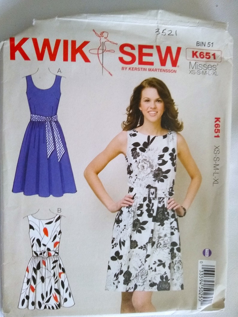 May include: Sewing pattern for a dress with a floral print and a solid blue dress. The pattern is called Kwik Sew K651 Misses' XS-S-M-L-XL.