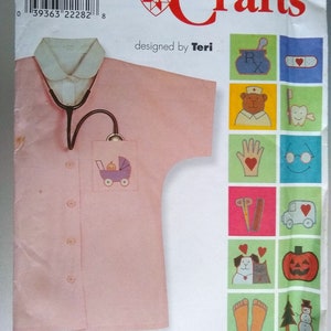 May include: A pink shirt with a pocket and a stethoscope, Simplicity Crafts pattern 8429, designed by Teri, with a variety of embroidery designs including a baby carriage, a teddy bear, a toothbrush, a heart, glasses, scissors, a truck, a dog and cat, a pumpkin, footprints, and a snowman.