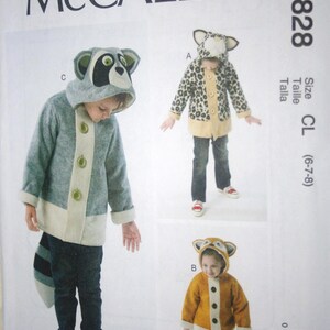 May include: McCall's M6828 sewing pattern for children's animal-themed hooded jackets. The pattern includes designs for a raccoon, leopard, and fox jacket, with sizes CL (6-7-8). The jackets feature button closures and contrasting trim.