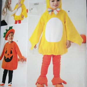 May include: Simplicity sewing pattern 2070 for children's costumes. The pattern includes instructions to make a chick and a pumpkin costume. The chick costume is yellow with a black beak and the pumpkin costume is orange with a jack-o'-lantern face.
