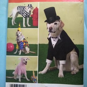 May include: Simplicity pattern 2519 for dog costumes. The pattern includes designs for a referee, clown, bunny, and tuxedo. The pattern is one size. The Simplicity logo is in red. The website is simplicity.com.