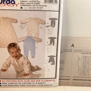 May include: A sewing pattern for a baby jumpsuit, sleeping bag, and combination garment. The pattern includes instructions in Spanish and English. The pattern number is 9782.
