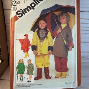 May include: Vintage Simplicity sewing pattern for children's rainwear, size 5-6. The cover features illustrations of children in raincoats, boots, and holding umbrellas. The pattern includes a special chart for working with plaids.