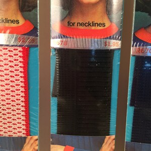 May include: Three packages of black elastic trim for necklines and sleeves. The packages feature a model wearing a red and white knit top with the trim. The price is listed as $1.95.