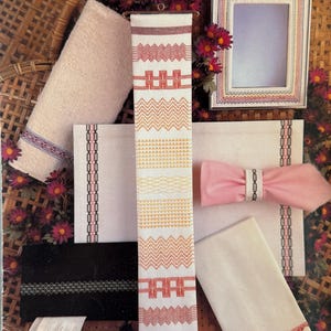 May include: A Leisure Arts instructional leaflet titled Teach Yourself Huck Weaving by Rosemary Drysdale. The cover displays various fabric items featuring huck embroidery patterns, including towels, a napkin ring, and a picture frame.