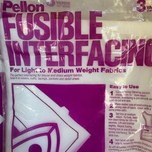 May include: A package of white Pellon Fusible Interfacing for light to medium weight fabrics. The clear plastic packaging features large purple text reading Pellon Fusible Interfacing, 3 yards, 18 inches wide, and includes printed instructions.