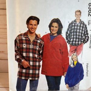 May include: A sewing pattern for four different styles of shirts. The pattern is for McCall's pattern number 0302. The shirts are a red, a blue, a plaid, and a white and black plaid.