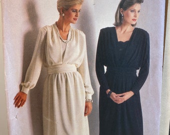May include: A vintage sewing pattern for two dresses. The pattern is from Butterick and is for size 10. The dresses are both knee-length and have long sleeves. One dress is white and the other is black.