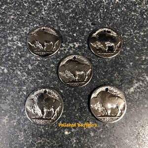 May include: Five silver nickel coins with a buffalo design and the words "FIVE CENTS". Each coin has a small hole at the top. The text "Polished Buffalo's" is visible in the image.