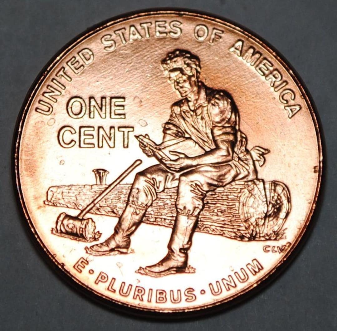 2009 Us Penny With Man Sitting On Log