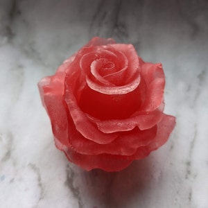 May include: A single, red, rose-shaped candle with a translucent, glossy finish.