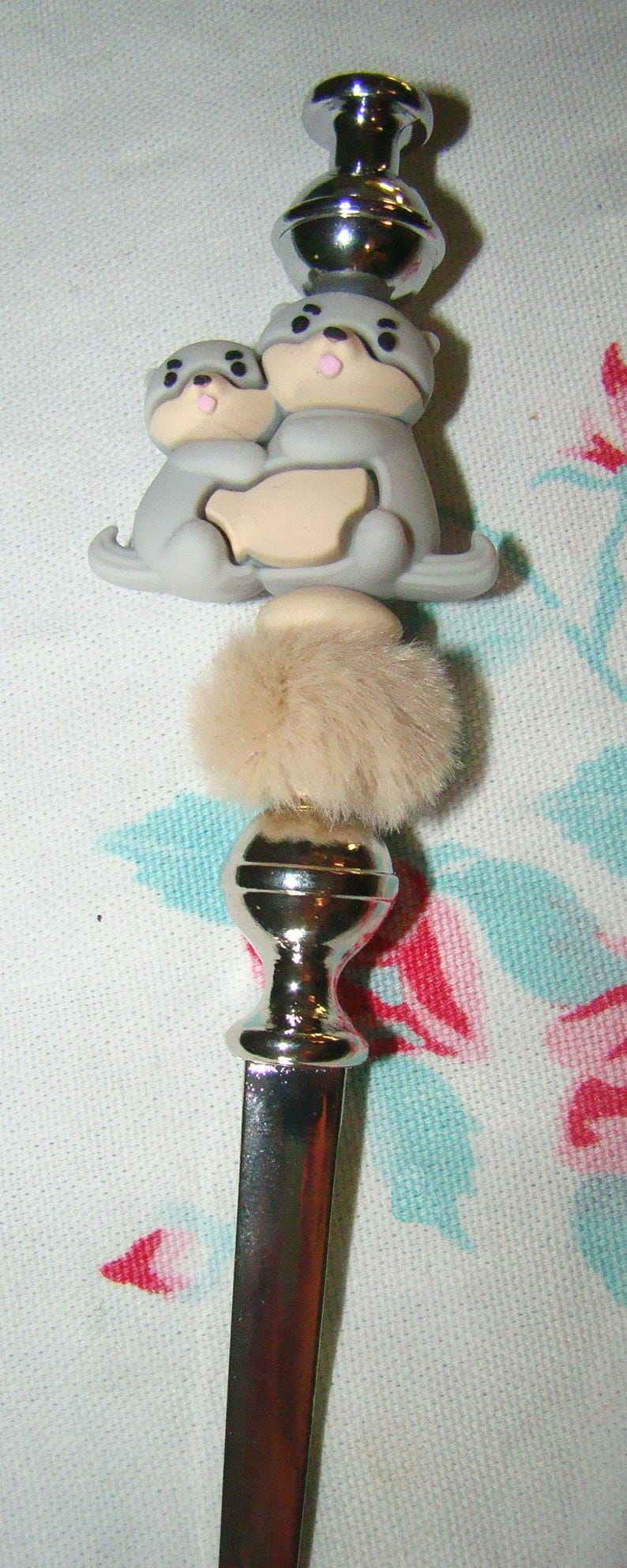 light gray otters letter opener desktop accessory