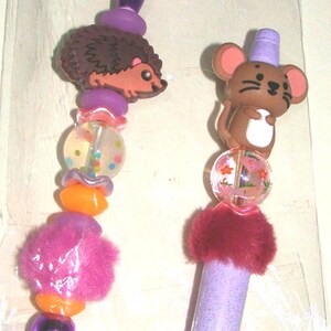 May include: A set of three ceramic vases in varying heights. The vases are white with a textured, ribbed design. The tallest vase is approximately 10 inches tall, the medium vase is 8 inches, and the smallest is 6 inches.