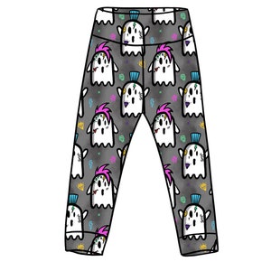 May include: Black leggings with a repeating pattern of white ghosts with pink and blue accents. The ghosts have a punk rock style with mohawks and tattoos.