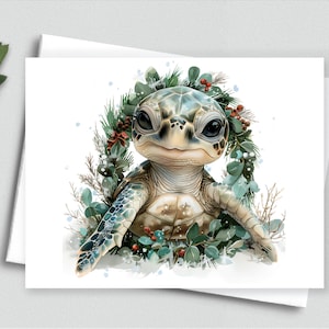 May include: A watercolor illustration of a baby sea turtle with a wreath of greenery and red berries. The turtle has a detailed shell and large, expressive eyes. The image is on a white card, suggesting a greeting card or print.