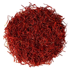May include: A close-up of a pile of dried saffron threads, a vibrant red-orange color. The threads are delicate and intertwined, creating a textured and visually appealing image.