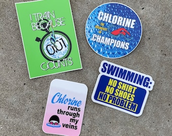 May include: Four colorful stickers with swimming-themed text and graphics. The stickers feature the phrases "I train because 0.01 counts", "Chlorine the breakfast of champions", "Chlorine runs through my veins", and "Swimming: No shirt, no shoes, no problem".