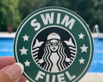 May include: A green and white sticker with a stylized mermaid wearing goggles and a swim cap. The sticker says "Swim Fuel" in a white circle with white stars around the edge.