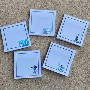 May include: Five white square sticky notes with blue borders. Each note has a different design. One note has the text "Swim Vibes" in blue and green. Another note has the text "diving diving diving vibes" in blue and green. The other three notes have illustrations of people swimming or diving.