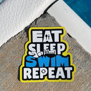 May include: Yellow and black sticker with the text "Eat Sleep Swim Repeat" in white letters. The word "Swim" is blue. A fork and spoon are above the word "Eat". A bed is above the word "Sleep". A swimmer is above the word "Swim". A circular arrow is above the word "Repeat".