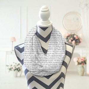 May include: A white fabric scarf with a gray chevron pattern. The scarf features a black and white print of a text passage about grace.