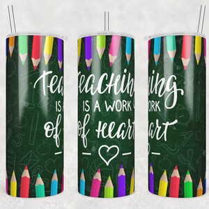 May include: Three stainless steel tumblers with a green chalkboard background and colorful pencils around the rim. The tumblers have the text "Teaching is a work of heart" with a heart symbol.
