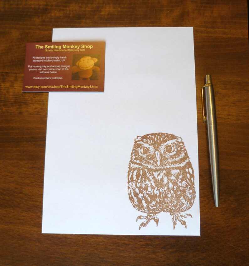 May include: A brown and white owl illustration printed on a white card. The card is part of a set of stationery featuring hand-stamped designs from The Smiling Monkey Shop. The shop's website address is included on the card.