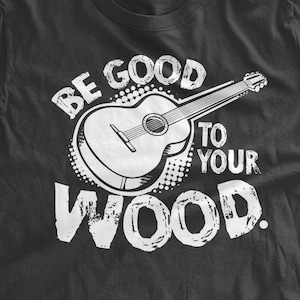 May include: Black t-shirt with a white graphic of a guitar and the text "Be good to your wood."
