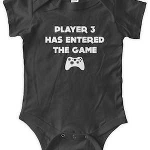 May include: Black baby grow with white text that reads "Player 3 has entered the game" and a white video game controller graphic.