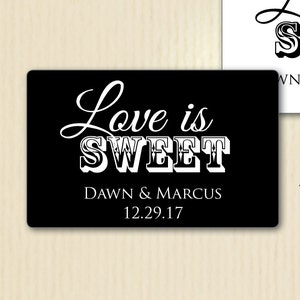 May include: Customized self-adhesive labels with the text "Love is Sweet." One label is black with white text and the names "Dawn & Marcus" and the date 12.29.17. The other label is white with black text and the text "WN'S Bridal Shower" and the date 12.8.17. Actual label size: 2.5 x 1.563 inches.