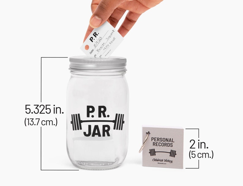 PR Jar™ for Personal Records, Weightlifting, Powerlifting, Crossfit. Jar is clear. Design is black. Coin slot lid is silver. Notepad included. The PR Jar™ is an original FitFizz creation that makes an excellent gift for yourself or any lifter.