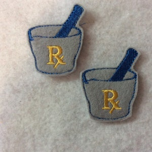 May include: Two gray felt patches with an embroidered image of a mortar and pestle with the symbol "Rx" in gold thread.