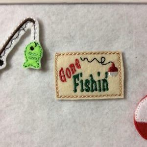 May include: Embroidered felt patches with a fishing theme. The patches include a fishing rod and fish, a sign that says "Gone Fishin'" with a bobber, and a red and white bobber.