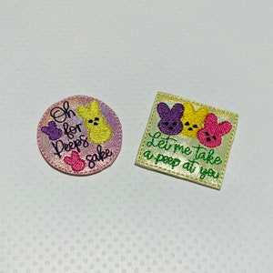 May include: Two embroidered iron-on patches featuring a pastel yellow, purple, and pink peep. The first patch says "Oh for Peep's sake" and the second patch says "Let me take a peep at you".
