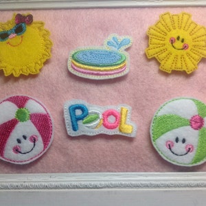 May include: Five embroidered felt patches with a summer theme. The patches include a yellow sun with a smiling face, a blue pool with a water splash, a white and pink beach ball with a smiling face, a white and green beach ball with a smiling face, and a white patch with the word "POOL" in colorful letters.