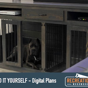 May include: A dark gray wooden dog crate with two separate compartments, each with a metal gate. The crate is designed to fit under a television and has a shelf above the crates. The text "BUILD IT YOURSELF - Digital Plans" is visible at the bottom of the image. A black dog is sitting inside one of the crates.