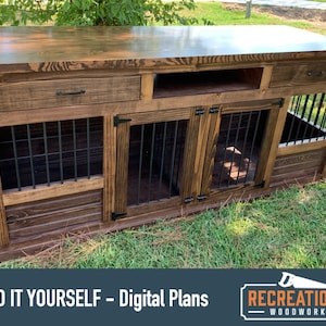 May include: A wooden dog crate with two separate compartments, a top shelf, and two drawers. The crate is stained a dark brown color and has black metal bars on the front of each compartment. The crate is sitting on a green grassy lawn. "BUILD IT YOURSELF - Digital Plans" and "RECREATIONAL WOODWORKER" are printed on the bottom of the image.
