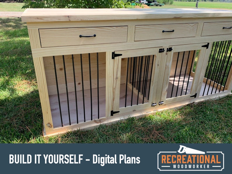May include: A wooden dog crate with two compartments and a top shelf with three drawers. The crate is made of light wood with black metal bars and black hardware. The crate is sitting on a green lawn. "BUILD IT YOURSELF - Digital Plans" and "RECREATIONAL WOODWORKER" are printed on the bottom of the image.