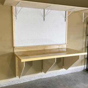 DIY Folding Workbench Plans - Easy to Follow Plans to build a sturdy space saving workbench for your garage, craft room, or shop.