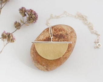 Pendant in brass and silver, on a silver chain • a sturdy half circle of brass on a fresh silver bar • minimalist and modern ••