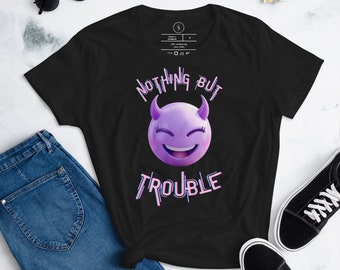 May include: Black t-shirt with a purple devil emoji and the text "Nothing But Trouble" in a glittery font.