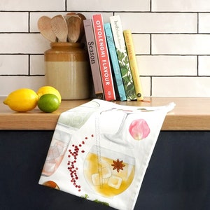 May include: White tea towel with a colorful illustration of cocktails and ingredients. The towel features a variety of drinks, including a gin and tonic, a margarita, and a Moscow mule. The towel is perfect for adding a touch of whimsy to your kitchen.