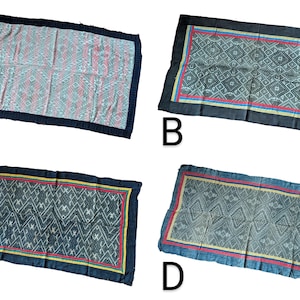 May include: Four rectangular textiles with geometric patterns and dark blue borders. The textiles feature various colour schemes, including pink, red, and yellow accents. The designs are intricate and detailed, showcasing a variety of shapes and lines.