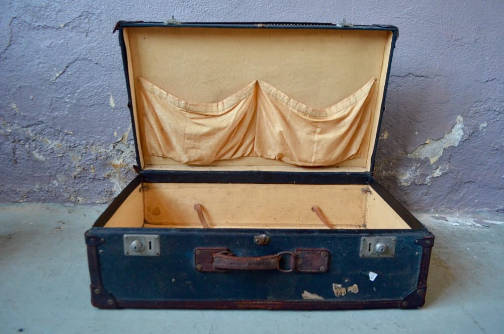 Louis Vuitton, a large and antique suitcase. Made of woo…
