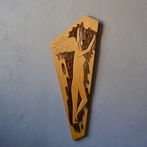 Carved wood panel in the style of raw art
